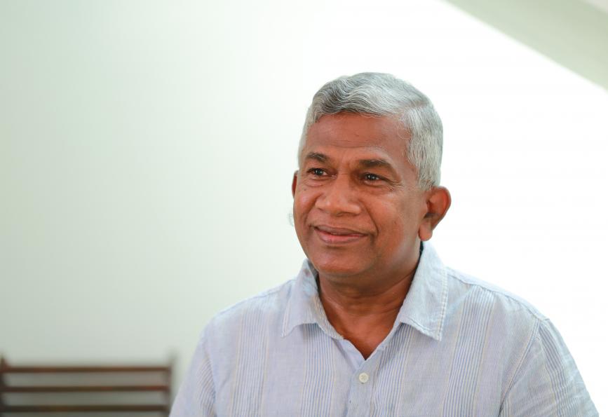 A photo of Mr D.D.C. Nawarathna sitting down and smiling
