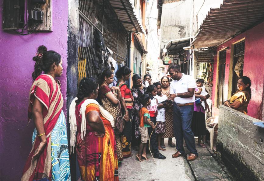 A World Mosquito Program staff member with community members in Sri Lanka