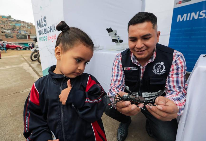 little girl being shown a toy mosquito_world mosquito program